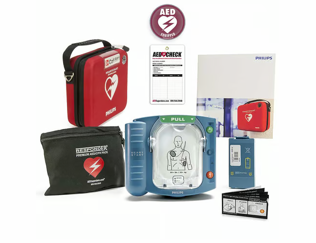 An AED laid out with all of its accessories, including a carrying case, pads, battery pack, and first responder kit.