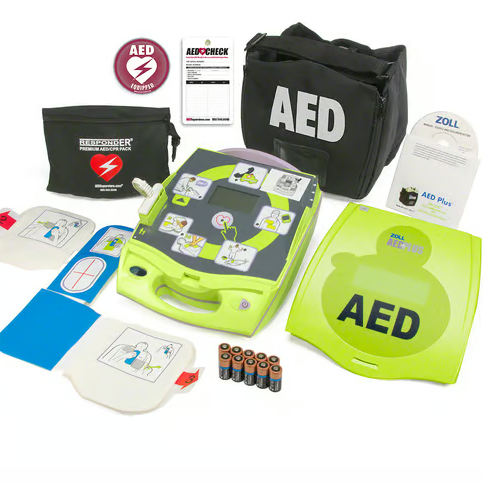 An AED laid out with all of its accessories, including a carrying case, electrode pads, batteries, and first responder kit.